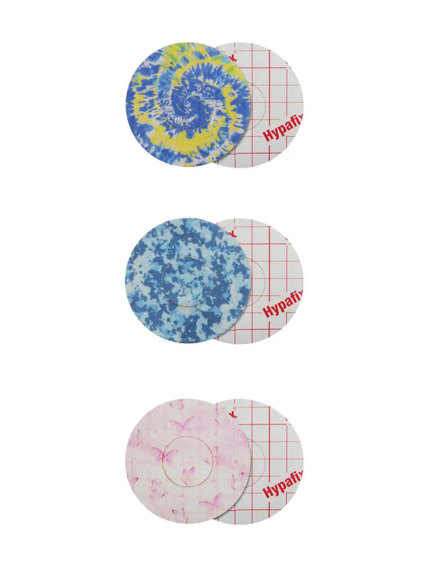 Colorful adhesive patches for Freestyle Libre 2, featuring tie-dye, blue camo, and pastel butterfly designs; secure and skin-friendly.