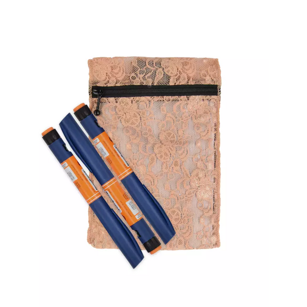 Insulin cooling wallet in lace design holding orange insulin pens.