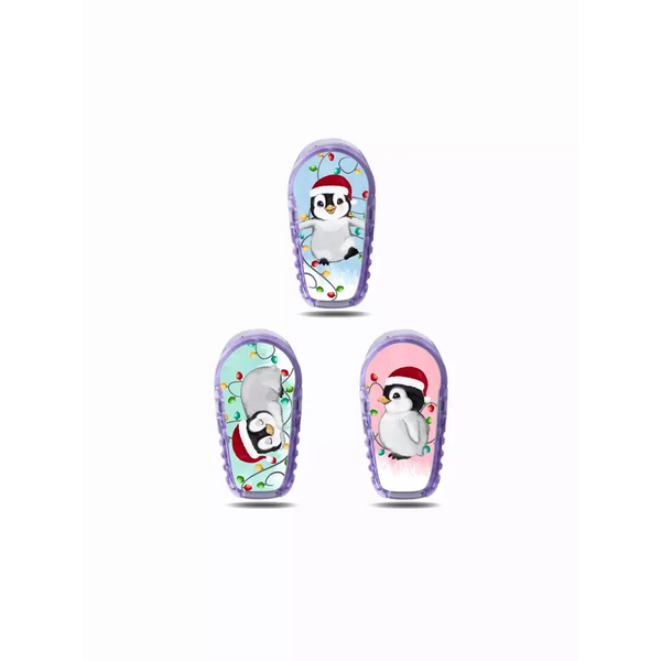 Cartoon penguin characters on colorful winter-themed Dexcom G6 Stickers for Christmas 2024