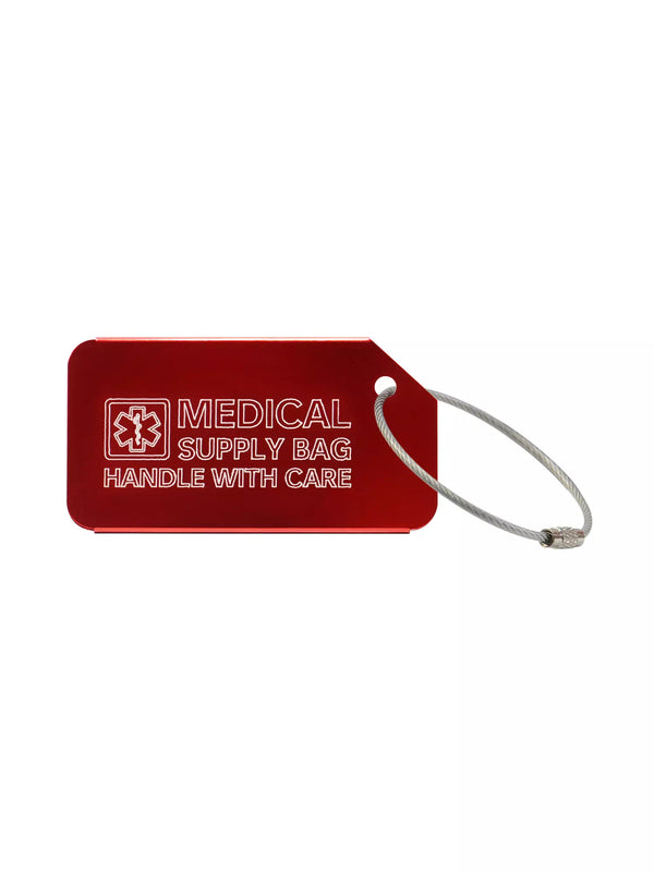 Red luggage tag with the text 'Medical Supply Bag Handle With Care' engraved.
