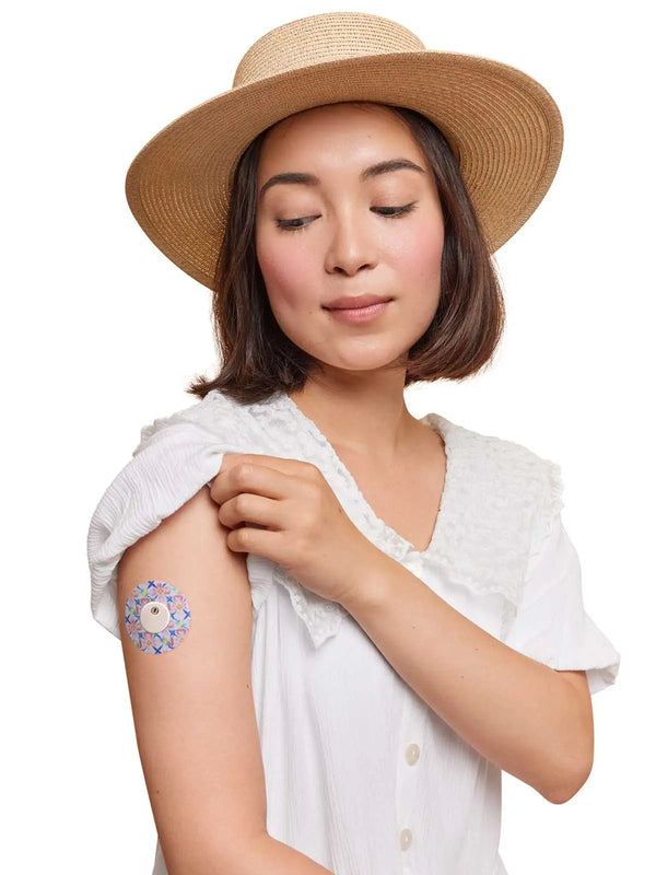 Woman wearing Freestyle Libre 3 sensor patch in spring-inspired design.