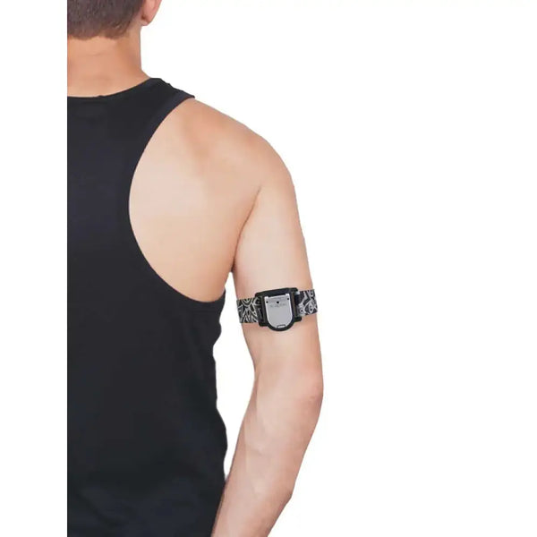 Man wearing GlucoMen Day CGM adjustable armband with blood glucose sensor on upper arm