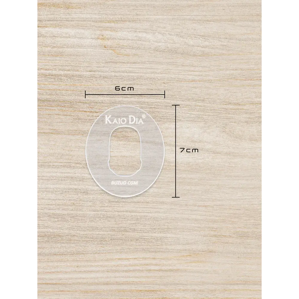 CGM sensor patch template for precise patch cutting on wooden surface.