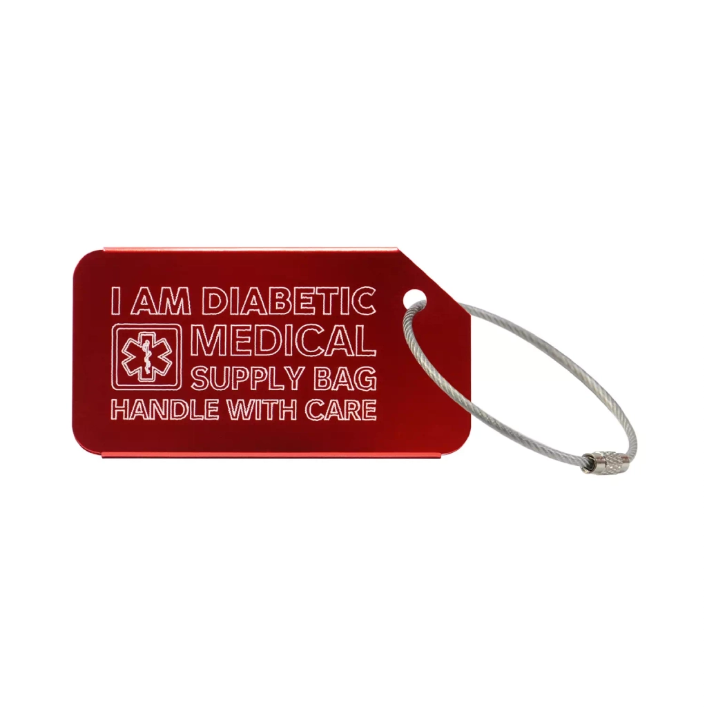 Red medical luggage tag with the text 'I Am Diabetic Medical Supply Bag Handle With Care' engraved. Immagine