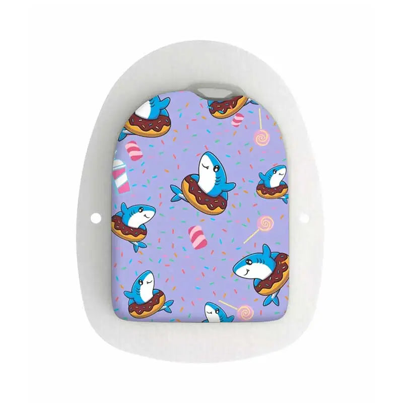A colorful Omnipod POD sticker featuring cute blue sharks floating in donuts on a purple background adorned with candy and sprinkles. Immagine