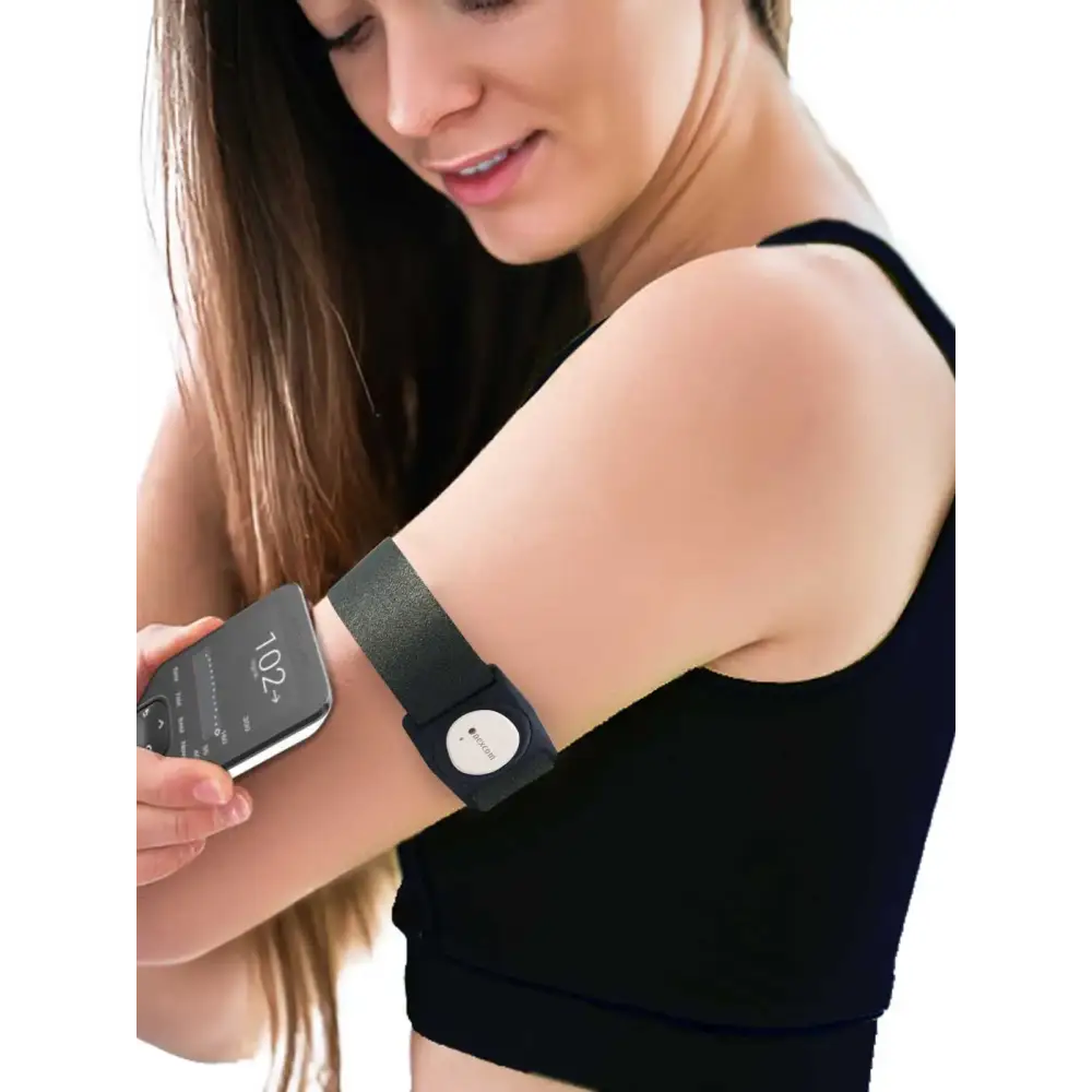 Dexcom G7 grey adjustable armband with rotating clip on woman's arm.