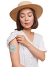 Dexcom G7 cookie shape patch worn on a woman’s arm, with breathable adhesive fabric for sensor support