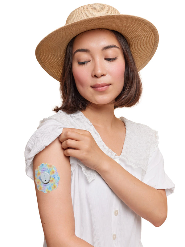 Dexcom G7 cookie shape patch worn on a woman’s arm, with breathable adhesive fabric for sensor support