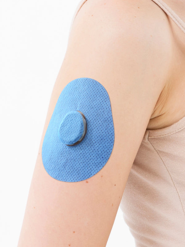 Dexcom G7 drop shape patch close-up on arm, showing breathable adhesive support around the sensor