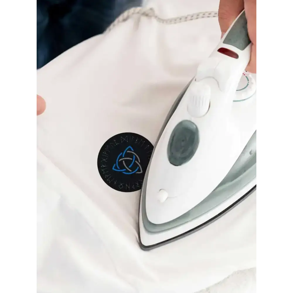 Diabetes awareness iron-on patch being applied to clothing with an iron, featuring a Viking-themed design.