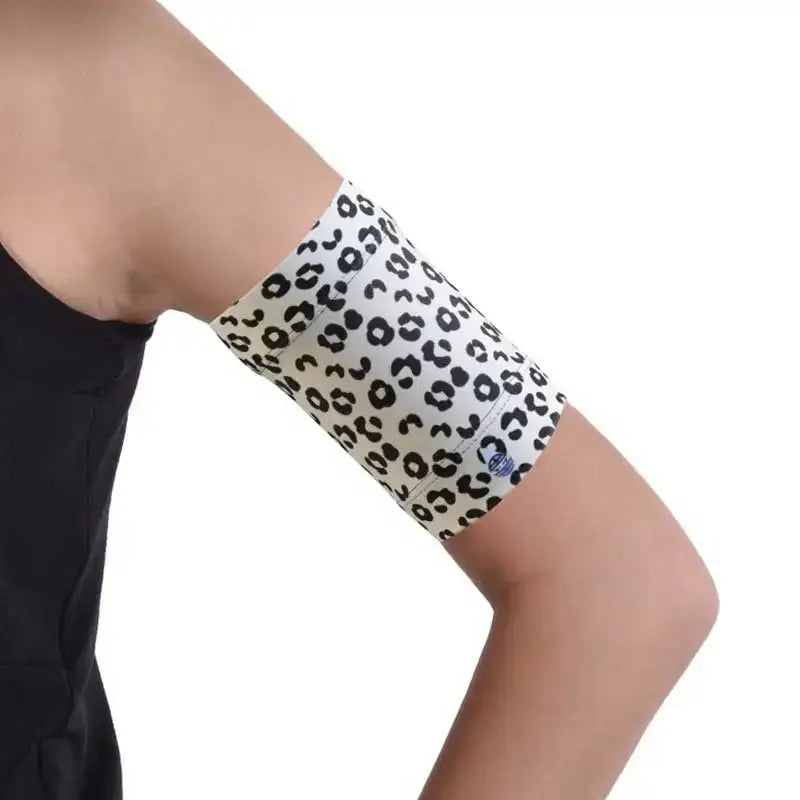 Leopard print elastic armband for blood glucose monitor, worn on arm.