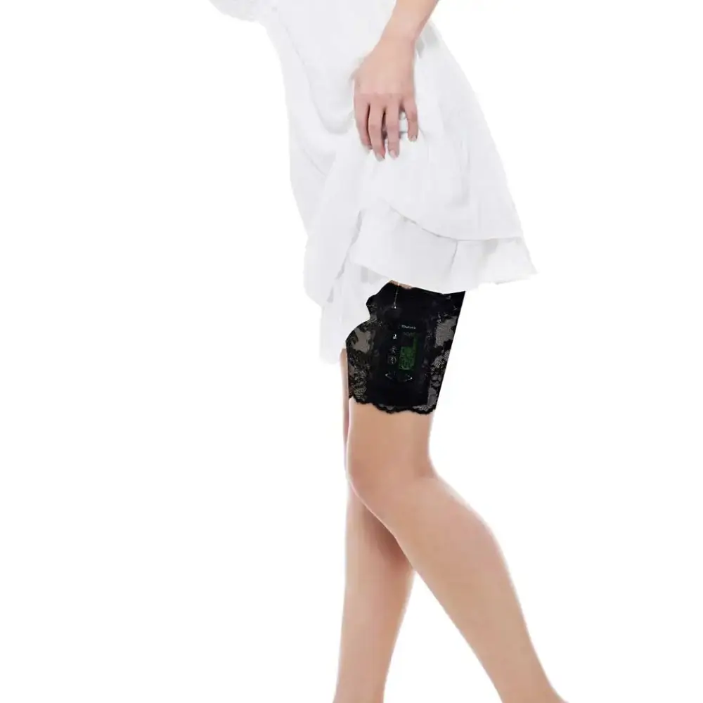 Black lace garter leg band securely holding an insulin pump under a white dress