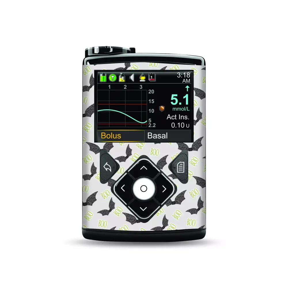 Medtronic MiniMed insulin pump with Halloween-themed stickers featuring bats and "boo" text.