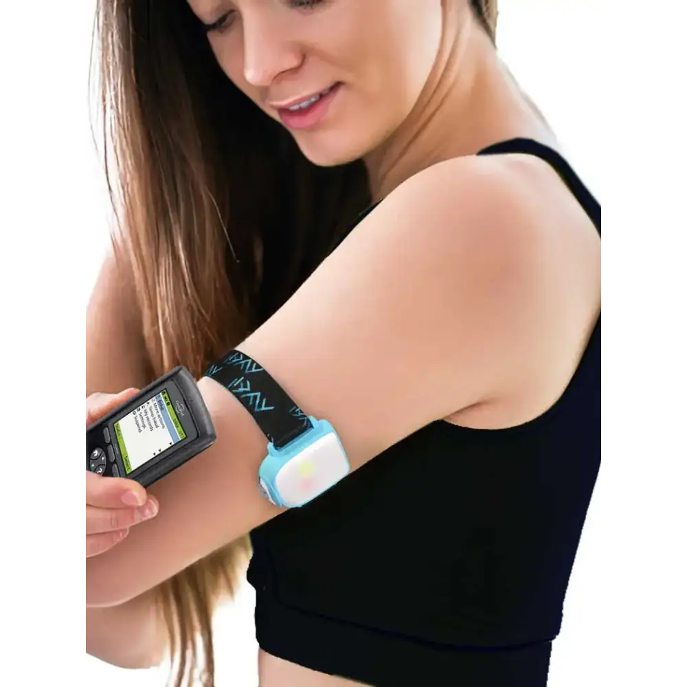 Omnipod insulin patch pump adjustable armband with colored clip in use on woman's upper arm.