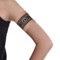 Narrow diabetic sensor armband on upper arm with decorative print.